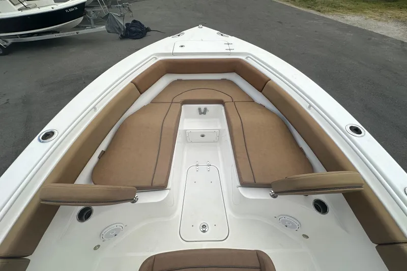 Slide: The Image of Bow view of 2020 Sea Hunt Ultra 255 SE in a boatyard under cloudy skies. - 77