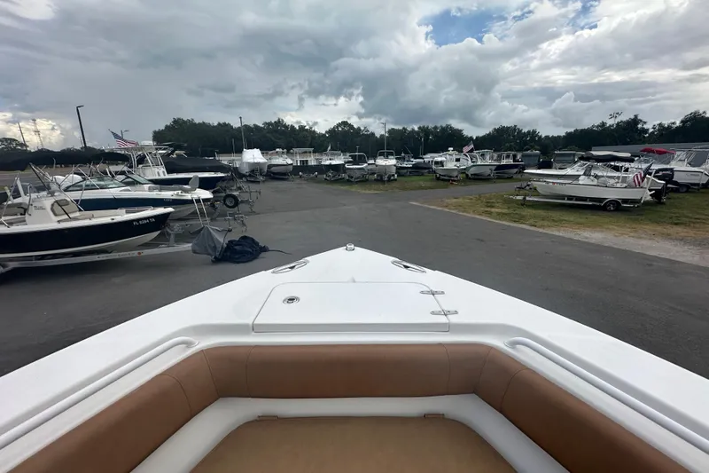 Slide: The Image of 2020 Sea Hunt Ultra 255 SE boat interior with brown seating and storage compartments. - 79