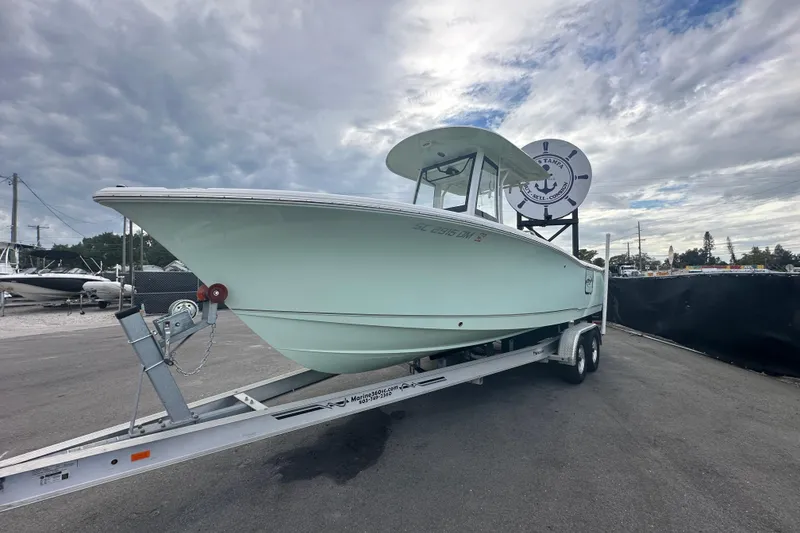 Slide: The Image of 2020 Sea Hunt Ultra 255 SE boat on trailer under cloudy sky. - 9