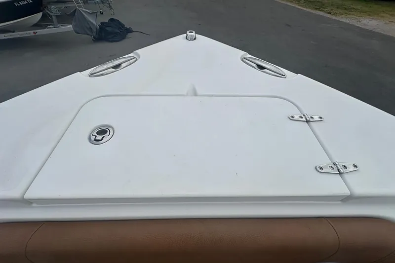 Slide: The Image of 2020 Sea Hunt Ultra 255 SE boat displayed at a dealership with sale signage. - 93