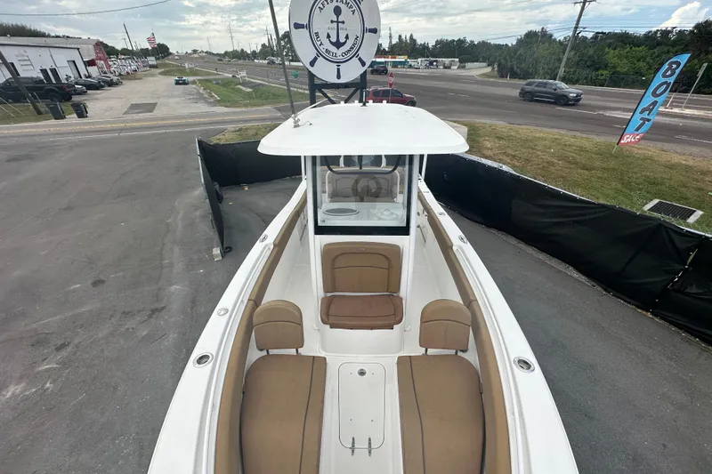 Slide: The Image of 2020 Sea Hunt Ultra 255 SE boat interior with brown cushioned seating. - 96