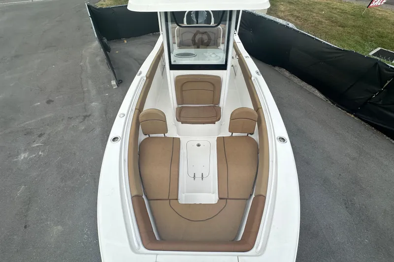 Slide: The Image of 2020 Sea Hunt Ultra 255 SE boat interior with tan seating and spacious layout. - 97