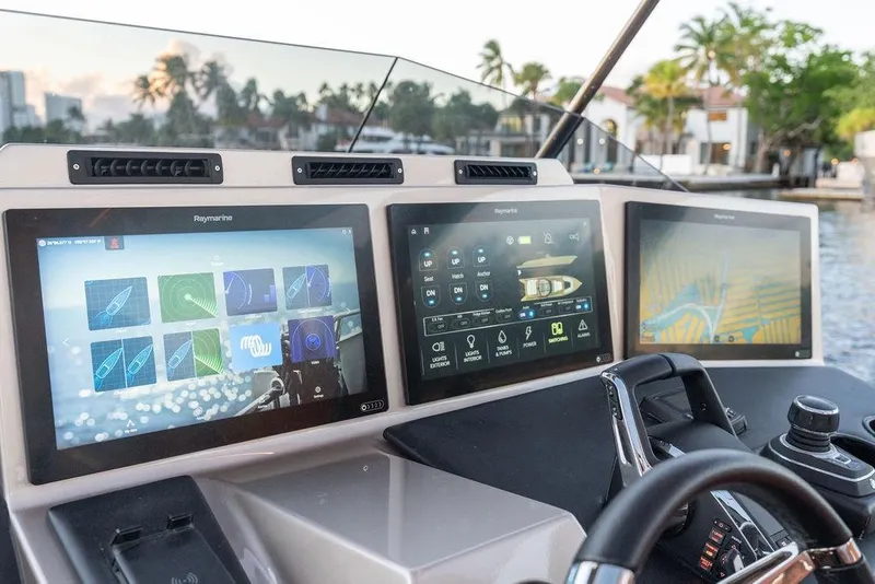 Slide: The Image of Modern DeKoning 43 yacht dashboard with advanced navigation screens, 2023 model. - 11
