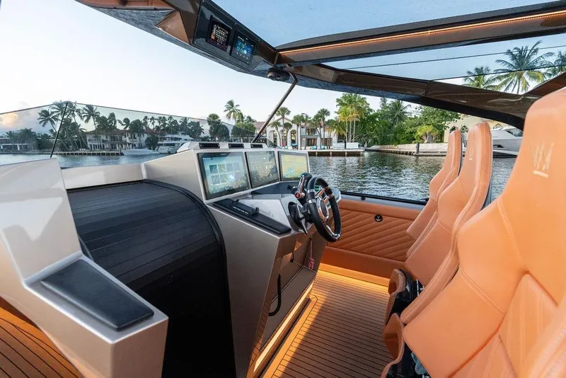 Slide: The Image of Luxurious 2023 DeKoning 43 yacht interior with advanced navigation system and plush seating. - 12