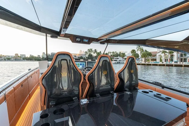 Slide: The Image of Luxurious 2023 DeKoning 43 yacht interior with sleek seating and waterfront view. - 13