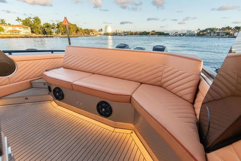 Slide: The Image of Luxurious seating on 2023 DeKoning 43 boat, with scenic waterfront view. - 18