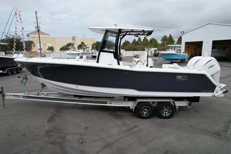 The Image of 2026 Sea Hunt Gamefish 27 Forward Seating boat on trailer, parked outdoors. - 0
