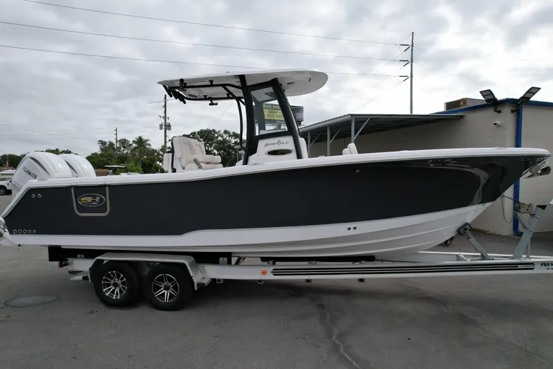 Slide: The Image of 2026 Sea Hunt Gamefish 27 Forward Seating boat on trailer, side view. - 2