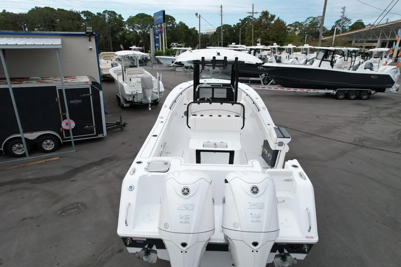 Slide: The Image of 2026 Sea Hunt Gamefish 27 boat with dual Yamaha engines in a dealership lot. - 3