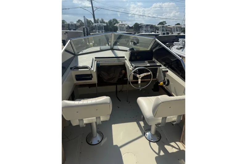 Slide: The Image of 1980 Boston Whaler Revenge 20 boat interior with steering wheel and seats. - 19