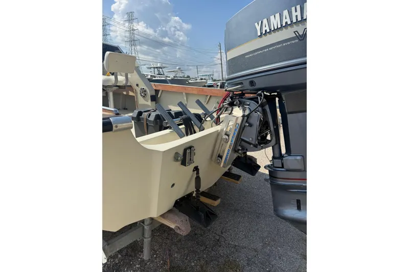Slide: The Image of 1980 Boston Whaler Revenge 20 with Yamaha outboard motor, parked outdoors. - 2