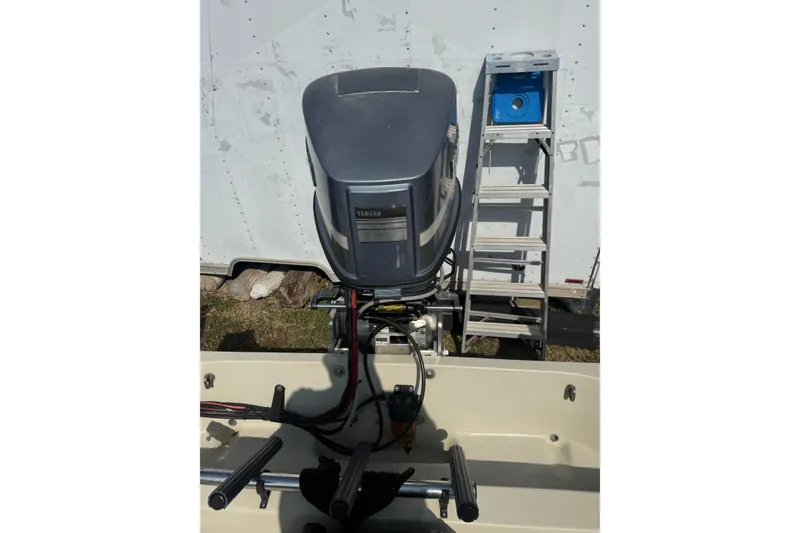 Slide: The Image of 1980 Boston Whaler Revenge 20 with Yamaha outboard motor and ladder in background. - 20