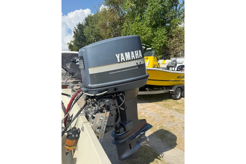 Slide: The Image of 1980 Boston Whaler Revenge 20 with Yamaha outboard motor in a sunny outdoor setting. - 23