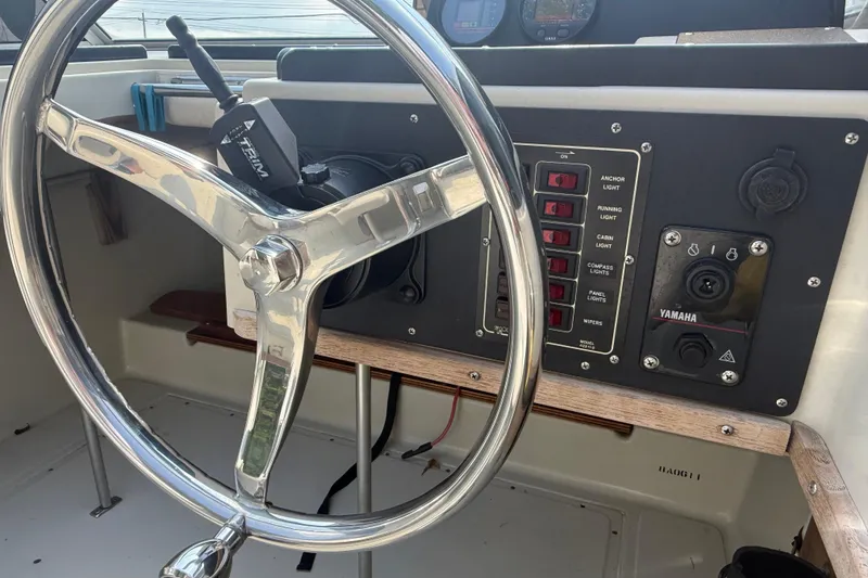 Slide: The Image of 1980 Boston Whaler Revenge 20 dashboard with steering wheel and control panel. - 9
