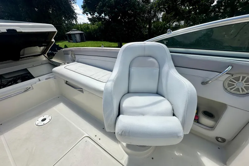 Slide: The Image of Interior of 2010 Sea Ray 280 Sundeck with white seating and open engine compartment. - 11