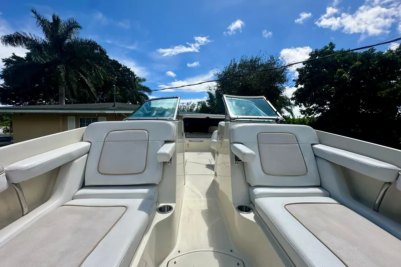 Slide: The Image of 2010 Sea Ray 280 Sundeck boat interior with seating, under a clear blue sky. - 13