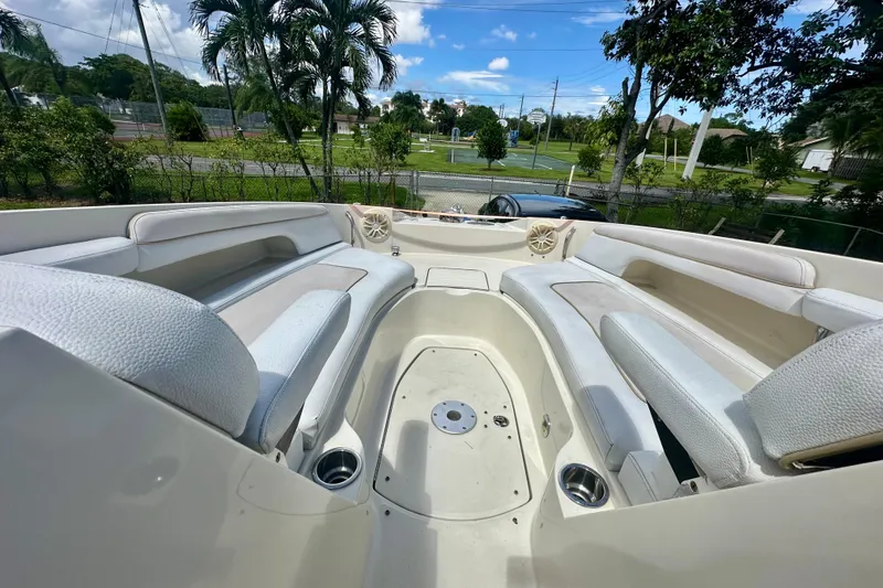 Slide: The Image of Spacious seating area on a 2010 Sea Ray 280 Sundeck boat, surrounded by lush greenery. - 20