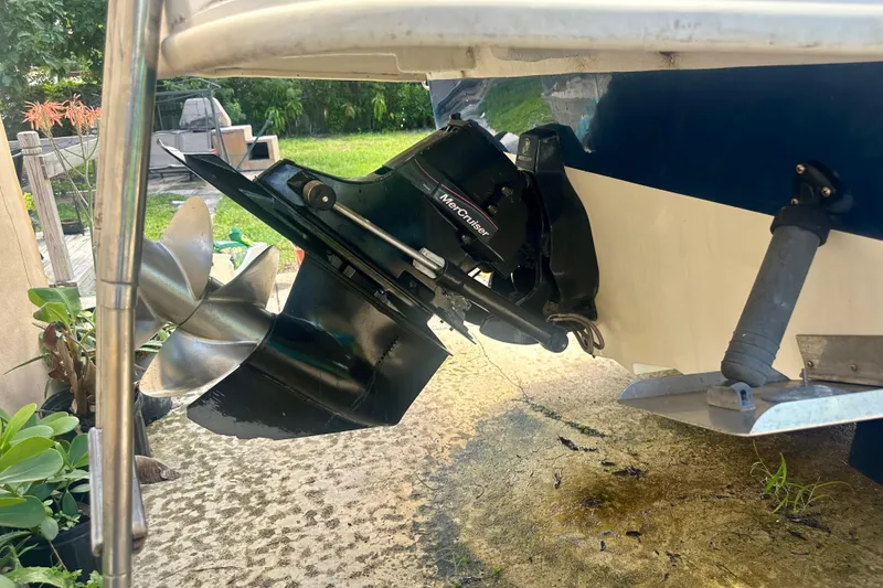 Slide: The Image of 2010 Sea Ray 280 Sundeck boat with MerCruiser outdrive and propeller, parked outdoors. - 32