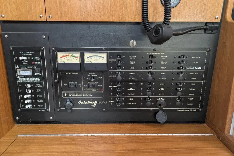 Slide: The Image of Electrical control panel of a 2008 Catalina 350 MkII yacht, featuring various switches and gauges. - 15