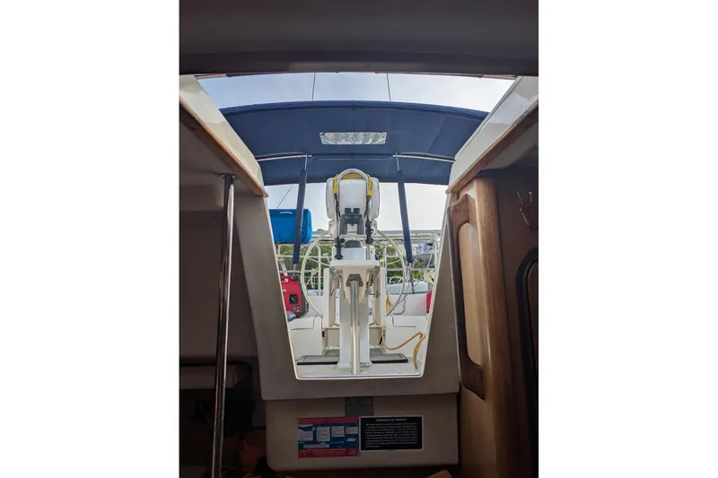 Slide: The Image of Interior view of a 2008 Catalina 350 MkII sailboat cockpit with blue canopy. - 4