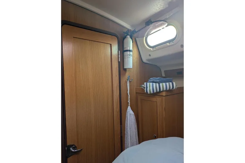 Slide: The Image of Interior of 2008 Catalina 350 MkII sailboat with wooden door and fire extinguisher. - 5