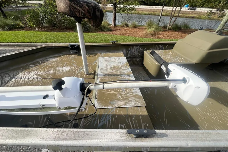 Slide: The Image of 2012 Tracker Grizzly 1754 SC boat interior with trolling motor and seating. - 5
