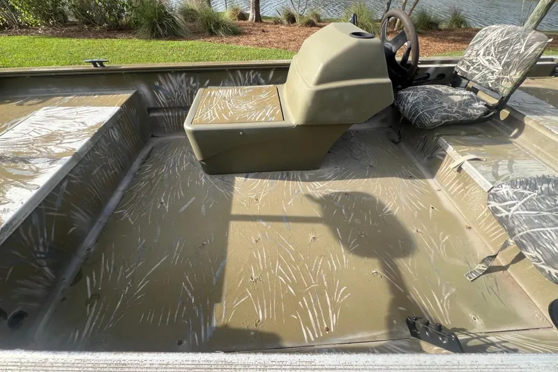 Slide: The Image of 2012 Tracker Grizzly 1754 SC boat interior with camouflage seats and steering console. - 6