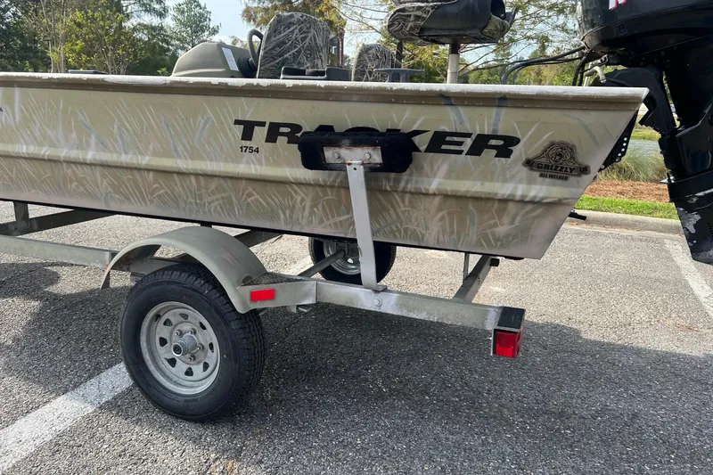 Slide: The Image of 2012 Tracker Grizzly 1754 SC boat on trailer in parking lot. - 8