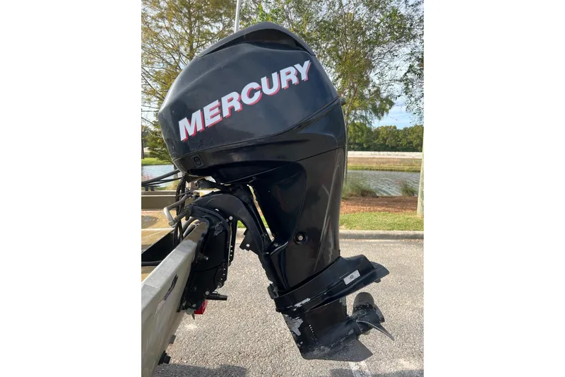 Slide: The Image of 2012 Tracker Grizzly 1754 SC with Mercury outboard motor, parked near a scenic waterway. - 9