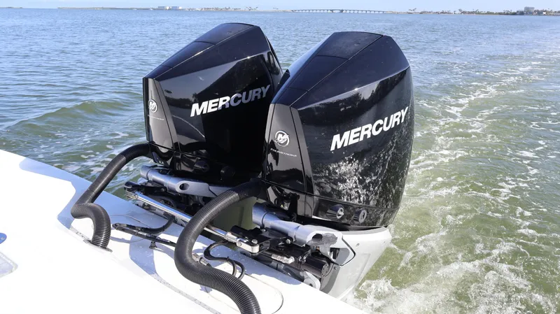 Slide: The Image of Twin Mercury engines on a 2022 Yellowfin 32 Offshore boat in open water. - 14