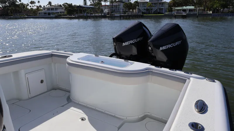 Slide: The Image of 2022 Yellowfin 32 Offshore boat with dual Mercury engines on a calm lake. - 15