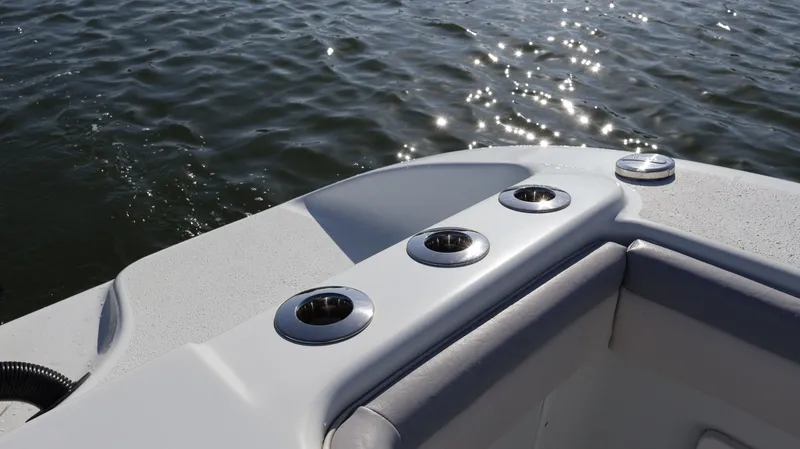 Slide: The Image of 2022 Yellowfin 32 Offshore boat deck with rod holders, on calm water. - 17