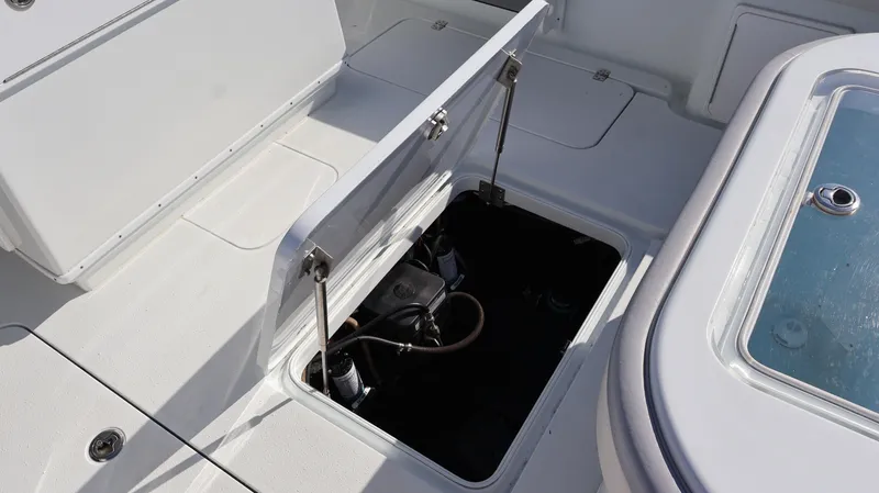 Slide: The Image of 2022 Yellowfin 32 Offshore boat storage compartment open on deck. - 19