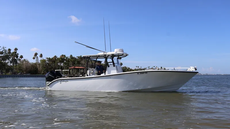 Slide: The Image of 2022 Yellowfin 32 Offshore boat cruising on calm waters under a clear blue sky. - 2