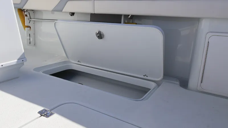 Slide: The Image of 2022 Yellowfin 32 Offshore boat storage compartment open on deck. - 21