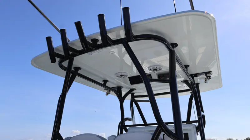 Slide: The Image of 2022 Yellowfin 32 Offshore boat with sturdy T-top and rod holders against blue sky. - 27