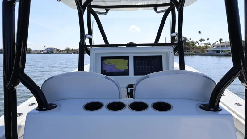 Slide: The Image of 2022 Yellowfin 32 Offshore boat dashboard with dual screens on a sunny day. - 28