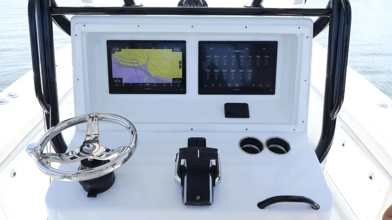 Slide: The Image of 2022 Yellowfin 32 Offshore boat console with dual screens and steering wheel. - 30