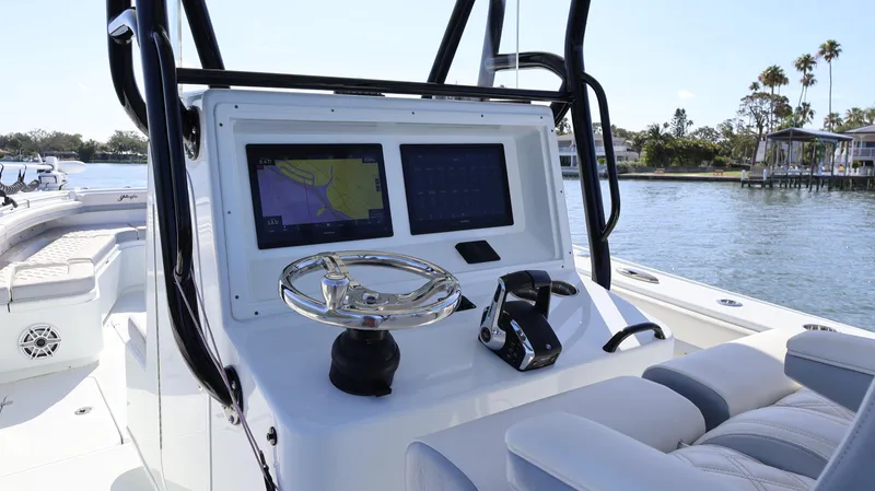 Slide: The Image of 2022 Yellowfin 32 Offshore boat console with dual screens and steering wheel. - 32