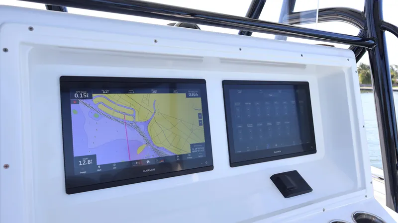 Slide: The Image of 2022 Yellowfin 32 Offshore dashboard with dual navigation screens displaying maps and controls. - 33