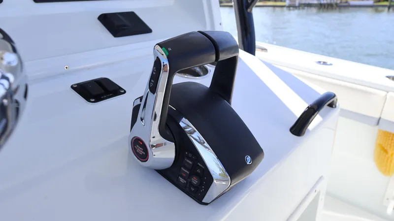 Slide: The Image of 2022 Yellowfin 32 Offshore boat throttle control on deck, near water. - 35