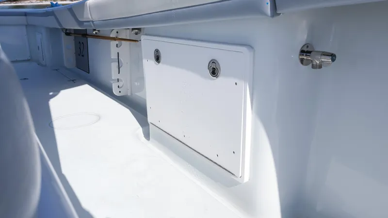Slide: The Image of 2022 Yellowfin 32 Offshore boat interior detail, featuring storage compartment and sleek design. - 40