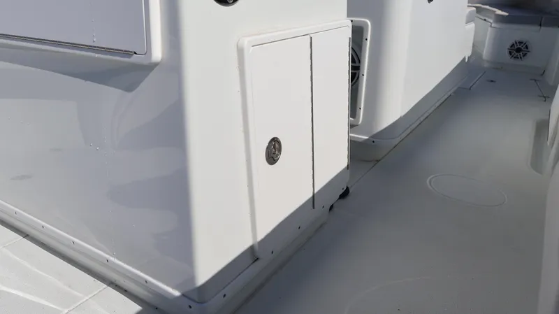 Slide: The Image of 2022 Yellowfin 32 Offshore boat deck, featuring sleek white design and storage compartments. - 41