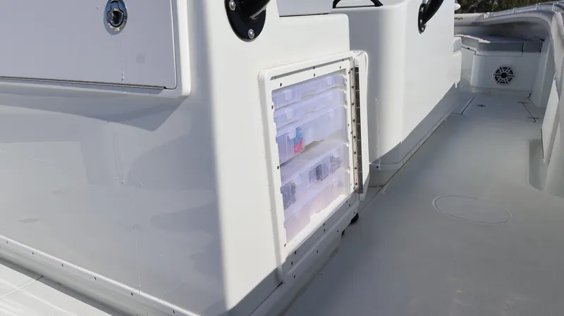 Slide: The Image of 2022 Yellowfin 32 Offshore boat with storage compartment and sleek white deck design. - 42