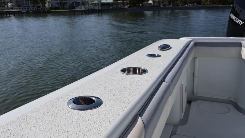 Slide: The Image of 2022 Yellowfin 32 Offshore boat deck with cup holders, near calm water. - 43