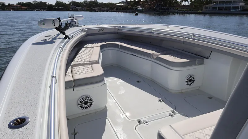 Slide: The Image of 2022 Yellowfin 32 Offshore boat with spacious seating and modern design on calm water. - 45