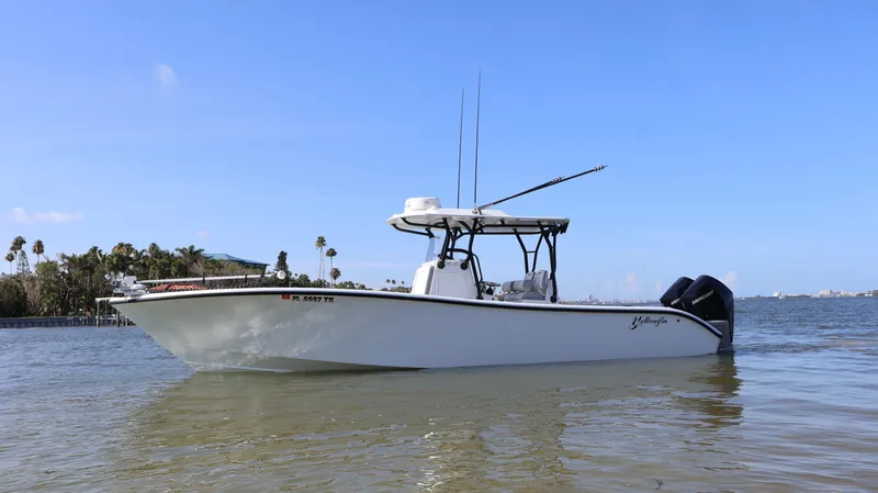 Slide: The Image of 2022 Yellowfin 32 Offshore boat on calm water, clear sky background. - 5