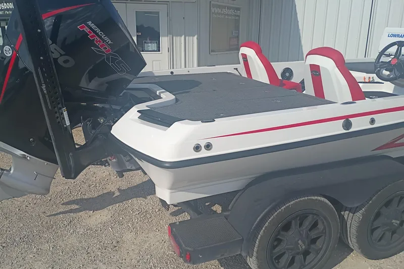 Slide: The Image of 2024 iKon LX21 boat with Mercury Pro XS engine, red and white seats, on a trailer. - 4