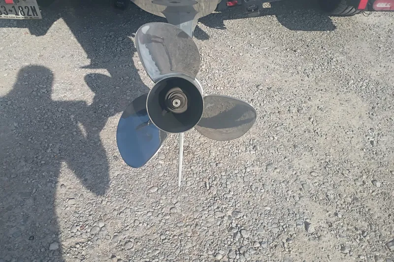 Slide: The Image of 2024 iKon LX21 boat propeller on gravel surface, casting shadow. - 9