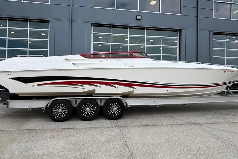 Slide: The Image of 2007 Fountain 38 Lightning speedboat on trailer, sleek design with red and black accents. - 1